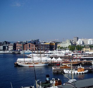 A sunny day in Oslo.  Boats on the water and a city-scape.